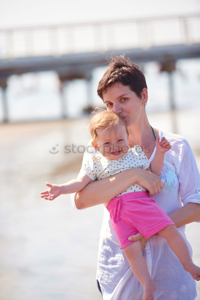 Similar – Young boy and his little sister sitting on jetty over the lake and dipping feet in water on sunny day in the summertime