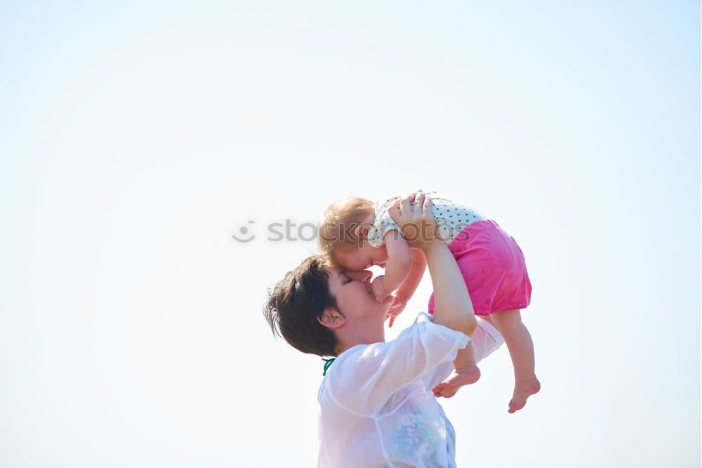 Father and son playing on the beach at the day time. Concept of friendly family.