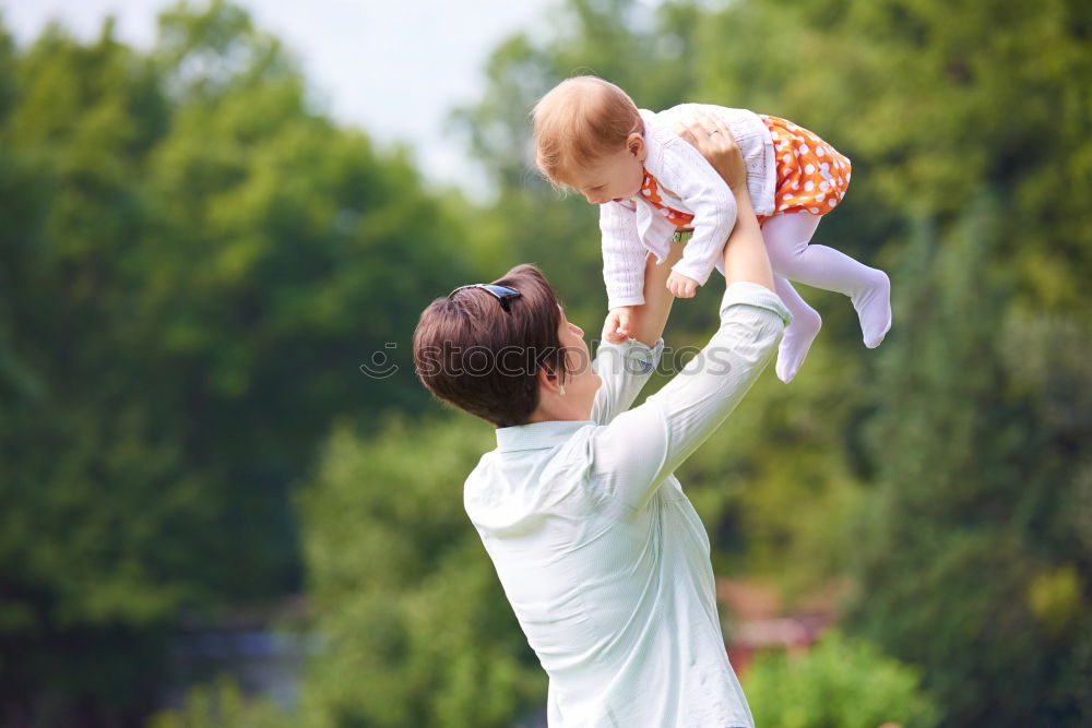 Similar – Mom reading a book her little daughter