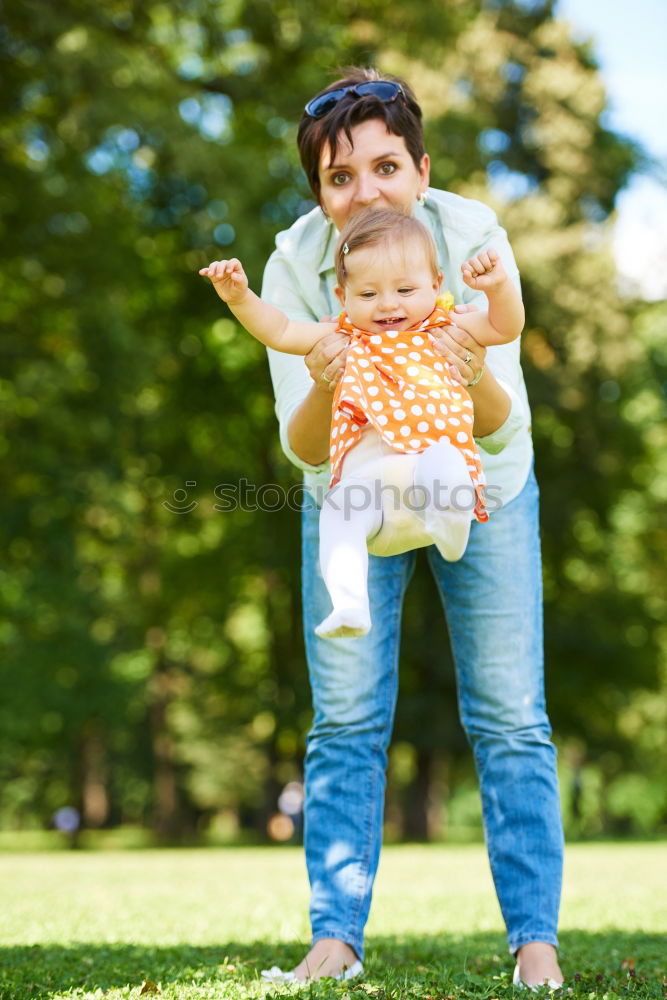 Similar – Image, Stock Photo Mother holding kid on hands in park