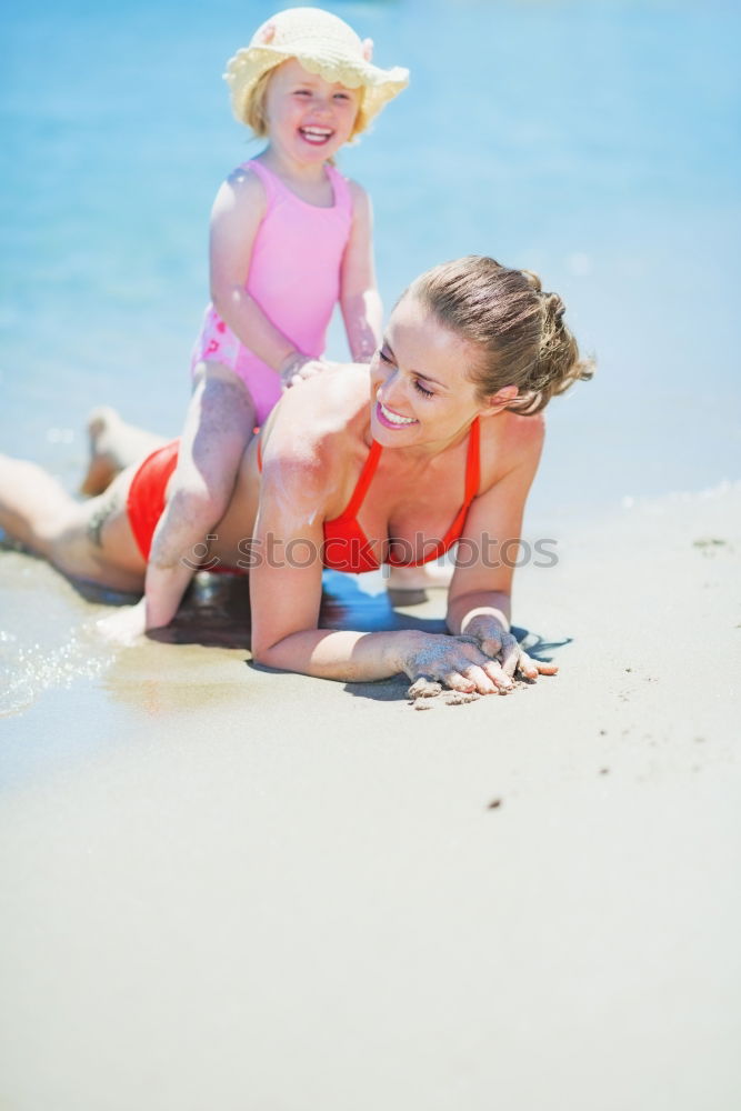 Similar – Image, Stock Photo Mother and toddler son playing with toys at beach