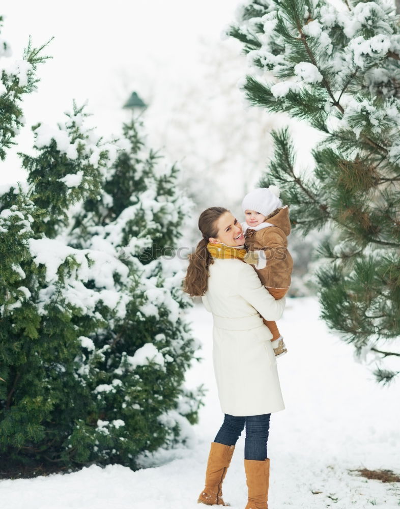 Similar – Teenage girl enjoying snow with her little sister. Children are walking through deep snow while snow falling, enjoying wintertime. Sisters spending time together. Girls are wearing winter clothes, young girl is wearing pink coat and wool cap