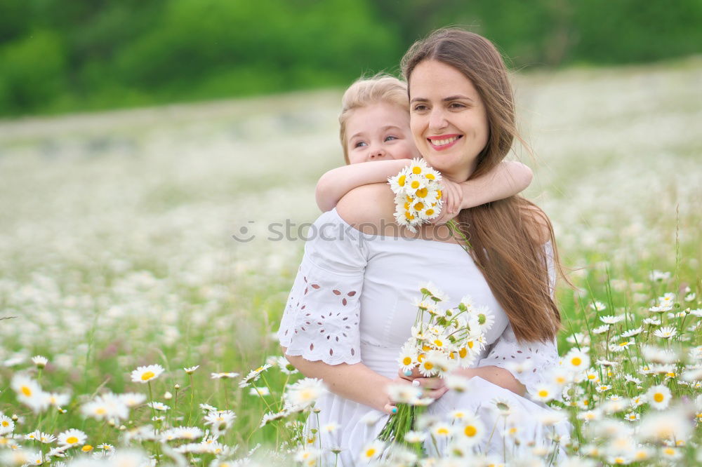 Similar – Image, Stock Photo Young happy mother embraced her cute little girl at canola field