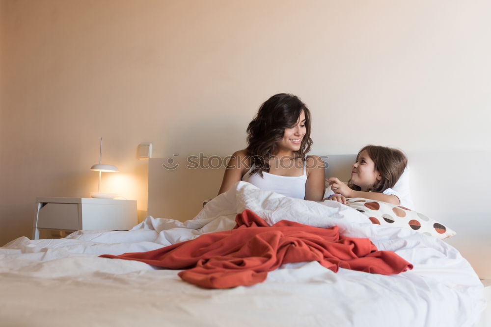 Similar – happy mother and child son playing pillow fight