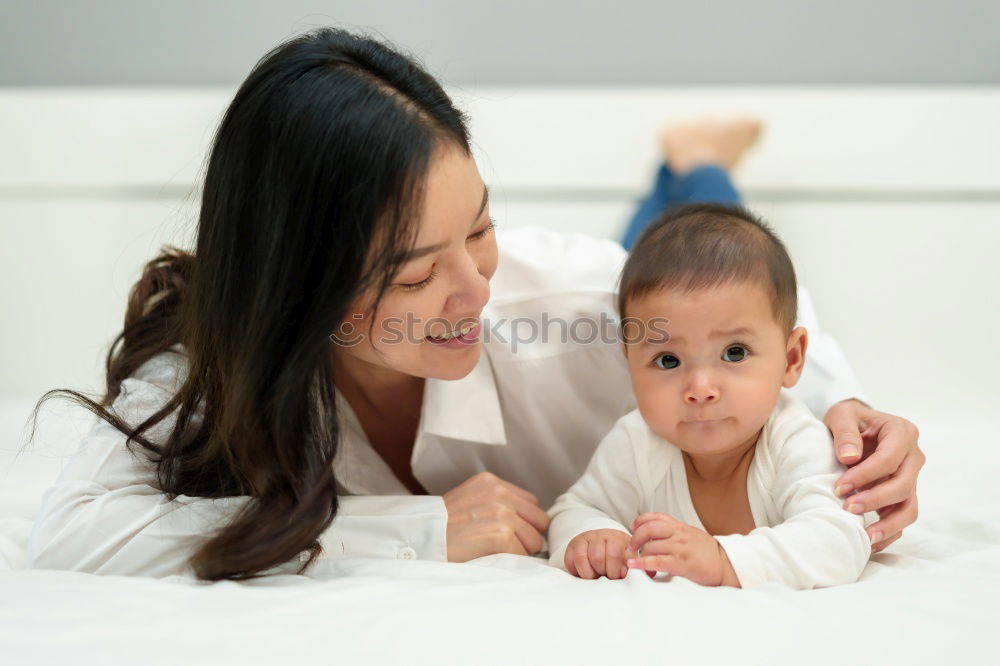 Similar – Image, Stock Photo Baby girl two months old smiling to her mother at home