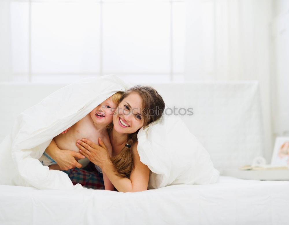 Similar – Two beautiful sisters playing on bed