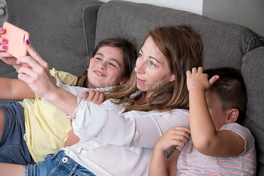 Similar – Image, Stock Photo Young women using mobile phones watching music clip, texting, messaging. Teenagers using the smartphones, sitting on sofa at home. Using technology devices. Girls wearing summer clothing