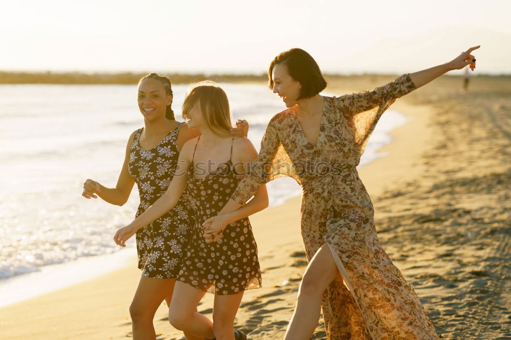 Similar – Image, Stock Photo Two young adult girlfriends chatting at beach and laughing