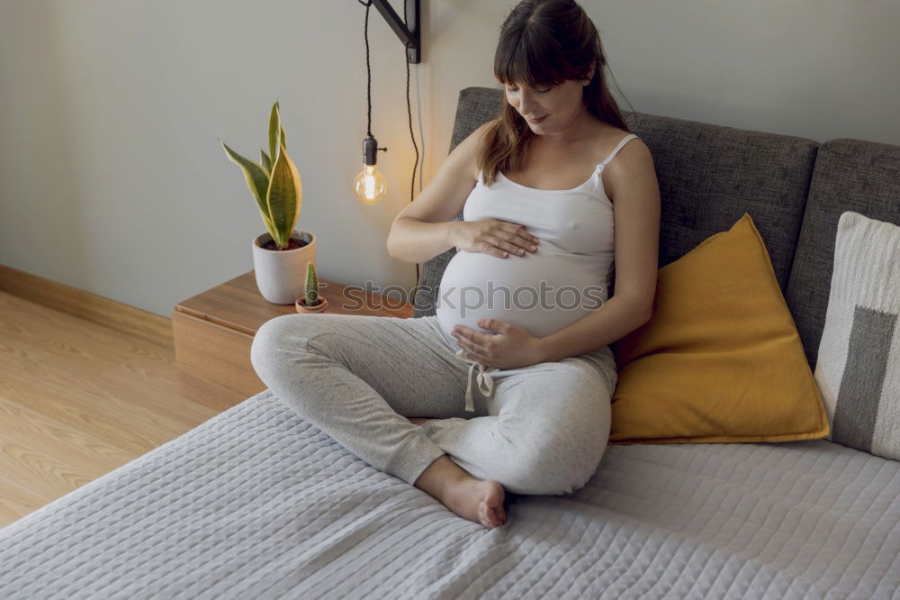 Similar – Pregnant woman touching her belly