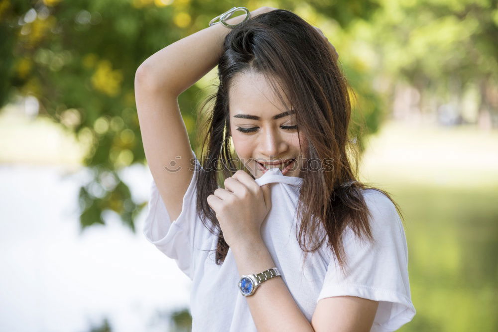 Similar – Brunette woman leaning on handrail at river