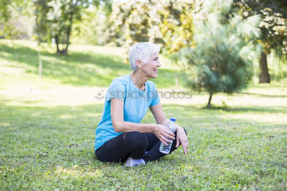 Similar – Image, Stock Photo blonde woman sitting in the grass and stretching in a park