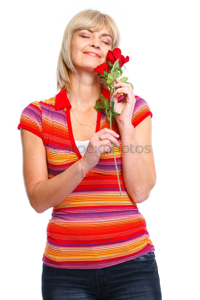 Similar – Redhead woman smelling a flower in a park