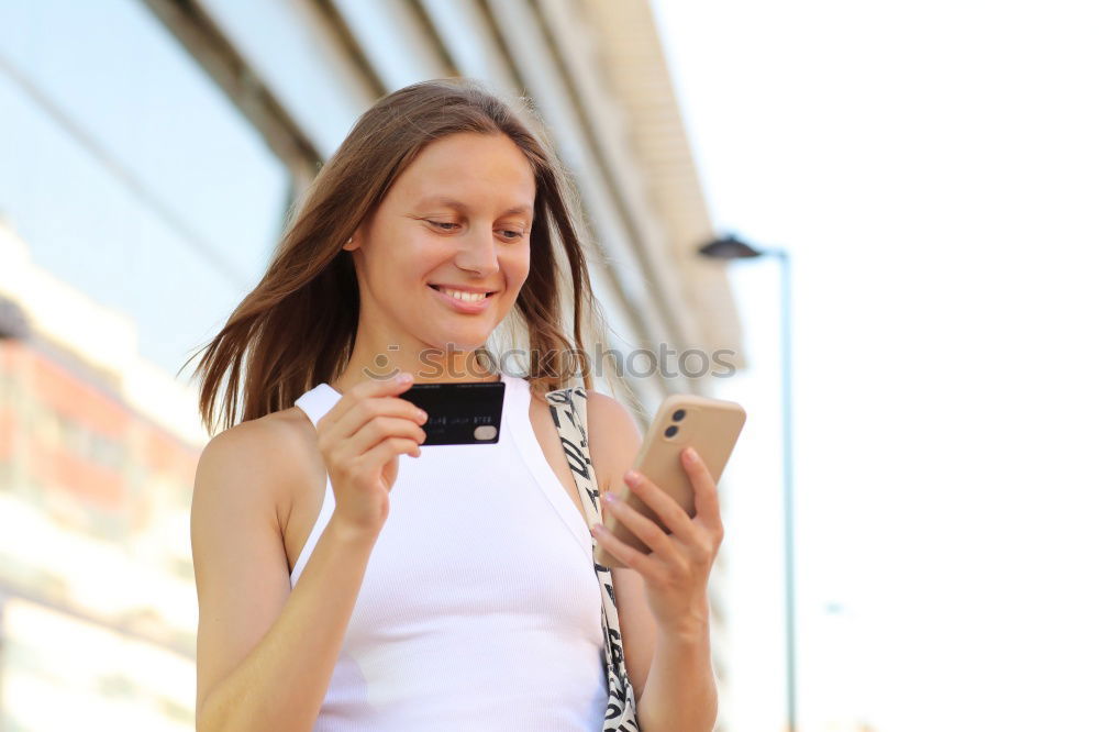 Similar – Young woman texting with a smartphone outdoors