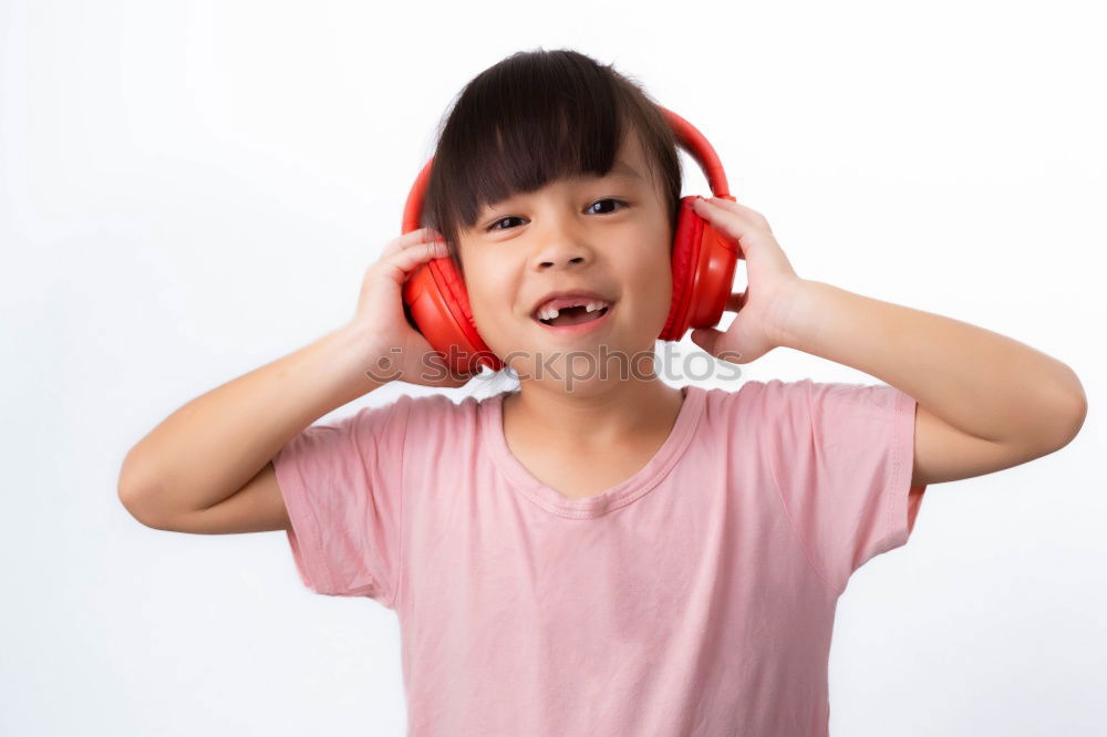 Similar – Child with headphones, listening to music