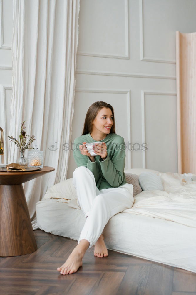 Similar – young tall woman sits on a light couch