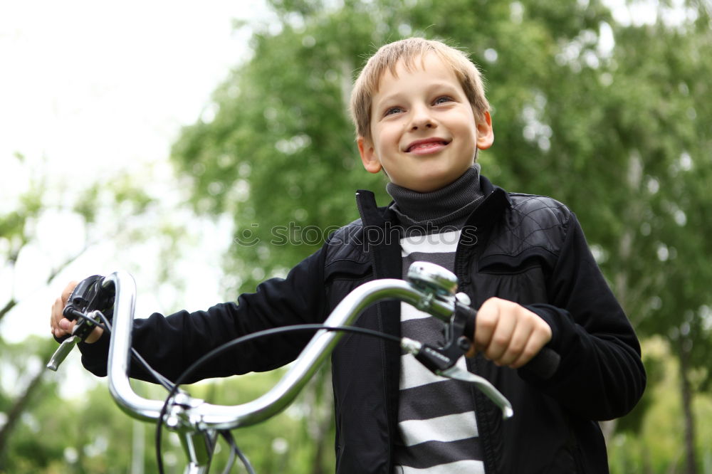 Similar – Image, Stock Photo Litle boy with a bike on a wooden door background