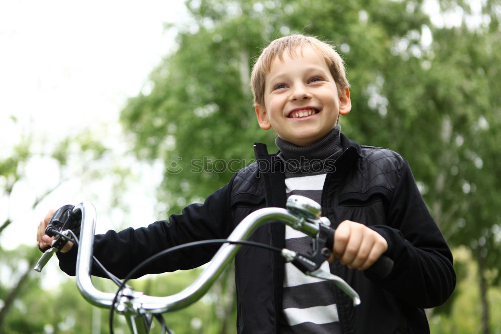 Similar – Image, Stock Photo Litle boy with a bike on a wooden door background