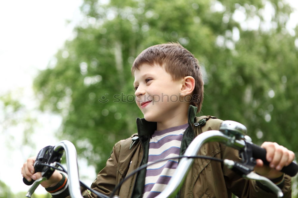 Similar – Image, Stock Photo Litle boy with a bike on a wooden door background