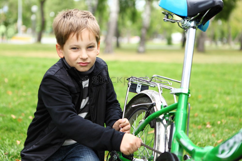 Similar – Image, Stock Photo Litle boy with a bike on a wooden door background