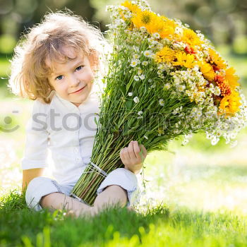 Similar – romantic portrait of happy child girl picking bouquet of beautiful blue delphinium flowers from summer garden