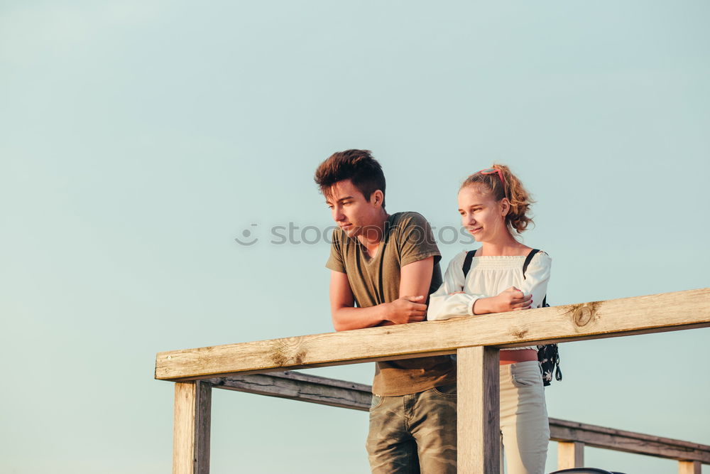 Image, Stock Photo Smiling young woman and man sitting on a pier over the sea