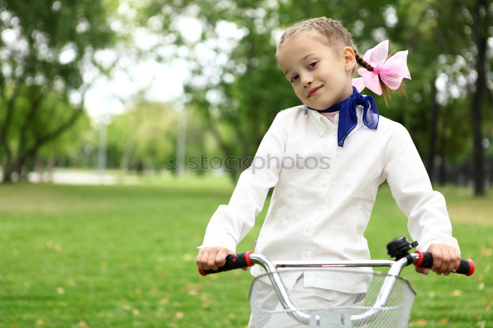 Similar – Cute girl driving bicycle in summer