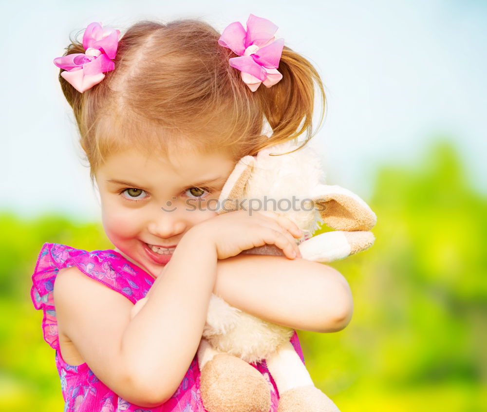 Young girl cuddles stuffy