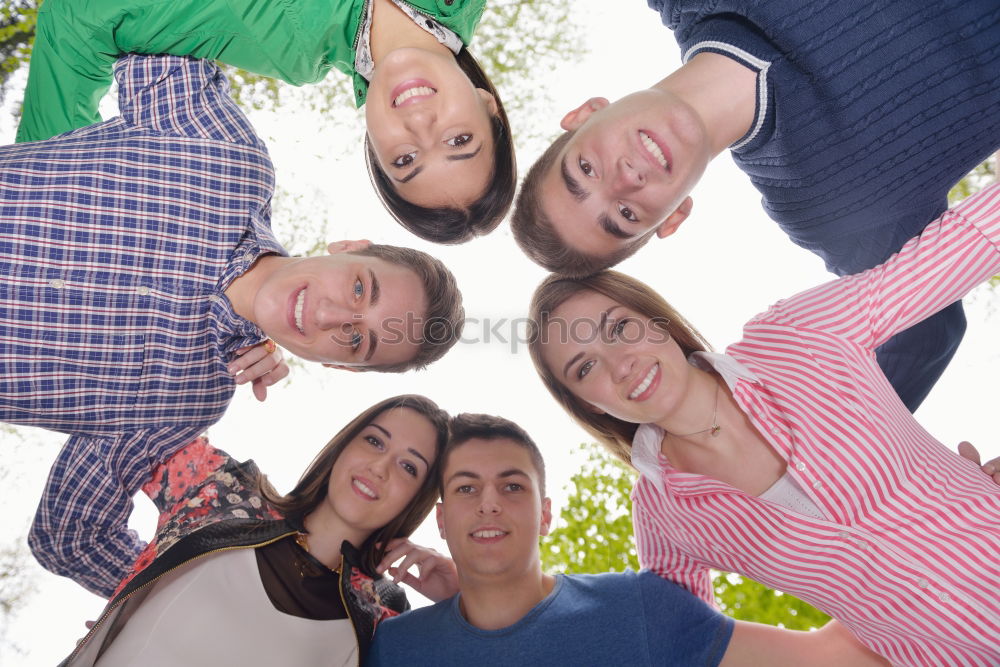 Similar – Women and men laying on grass wearing casual clothes.