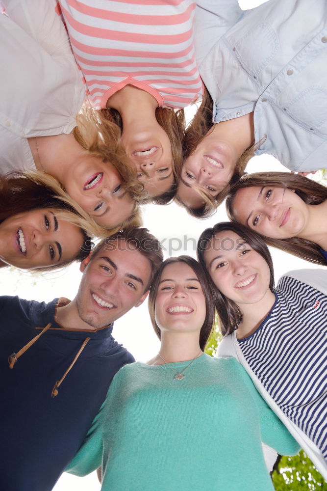 Similar – Women and men laying on grass wearing casual clothes.