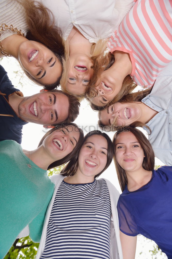 Similar – Women and men laying on grass wearing casual clothes.