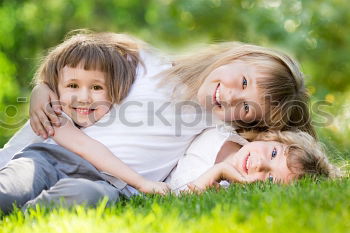 Similar – Two happy children playing near a tree on the grass