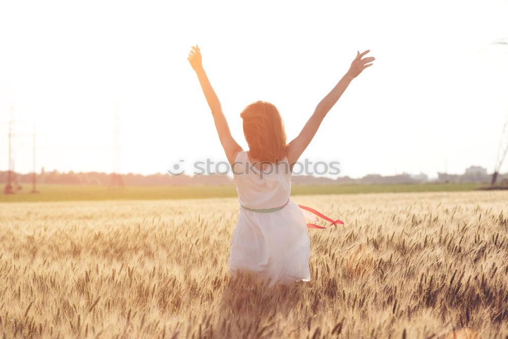 Similar – Image, Stock Photo Back view of a young woman in nature in a sunny autumn day