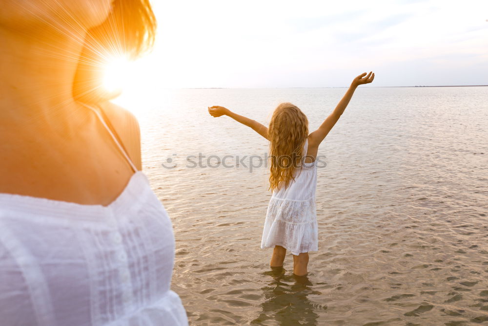 Similar – Image, Stock Photo Mother and son playing on the beach at the sunset time. People having fun outdoors. Concept of happy vacation and friendly family.