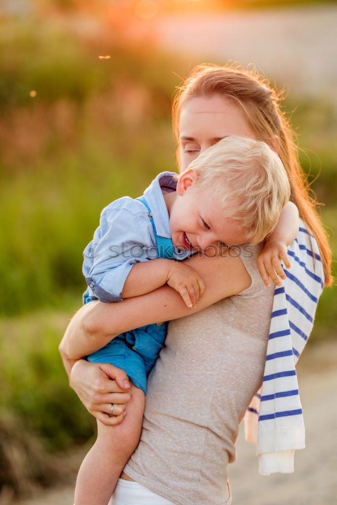 Similar – Baby girl standing on a bench hugging to woman