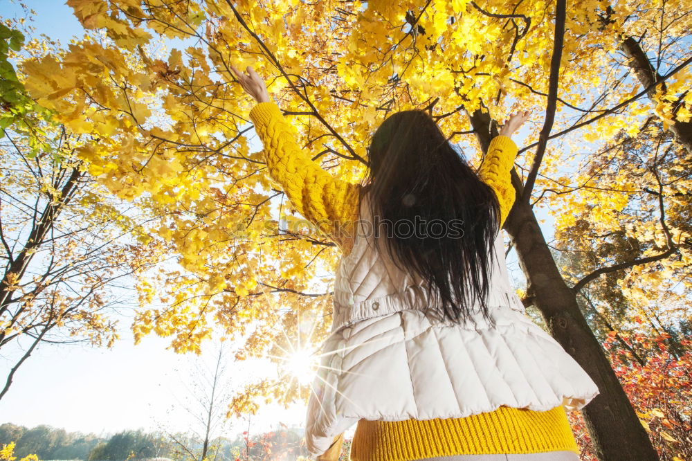 A young woman looking at a tree.