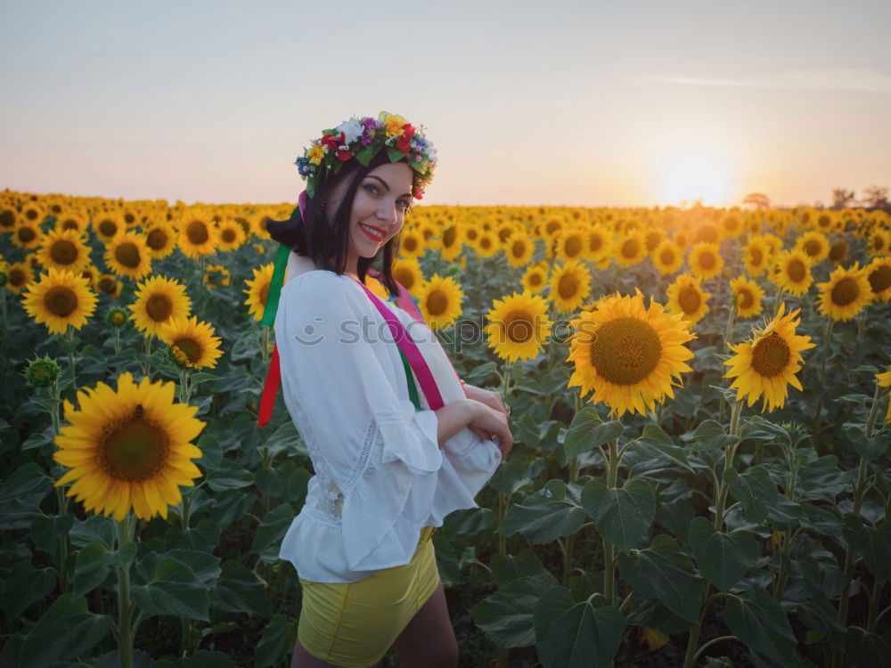 Similar – Image, Stock Photo Happy young black woman walking in a sunflower field