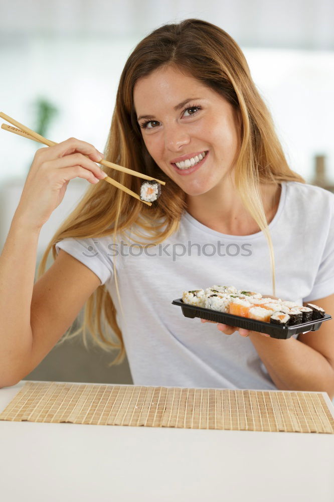 Crop woman eating sushi