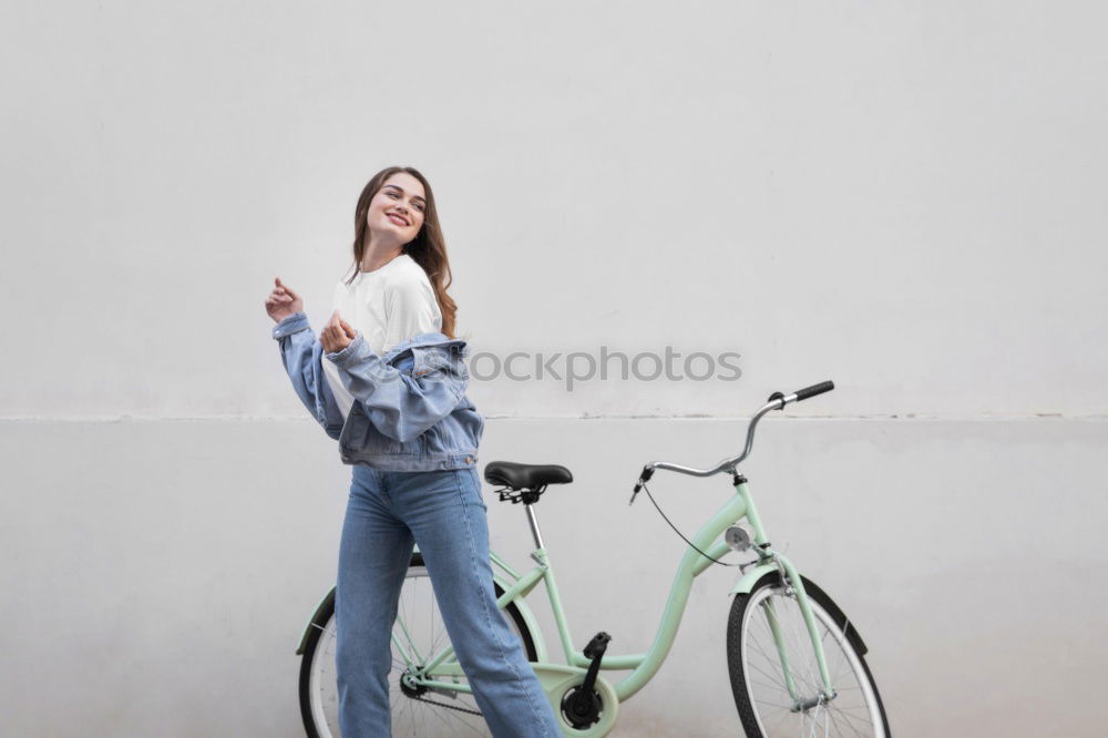 Similar – Young modern hipster riding bike trough urban city while sunset