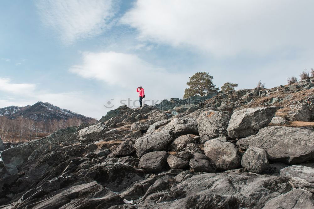 Similar – A photographer takes a picture of the view on Isle of Skye II