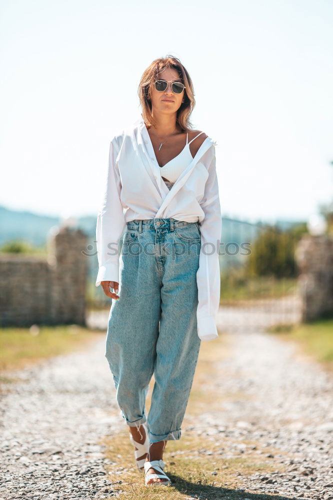 Similar – Image, Stock Photo Happy young blond woman standing on urban background.
