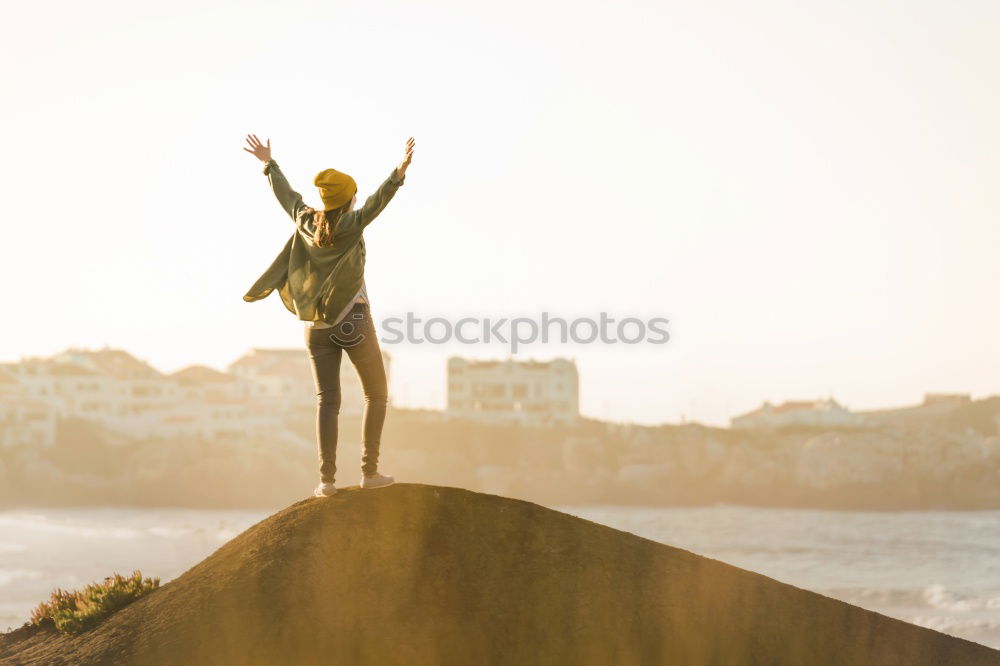 Similar – Man with tattoos holding skateboard at shore. Back view.