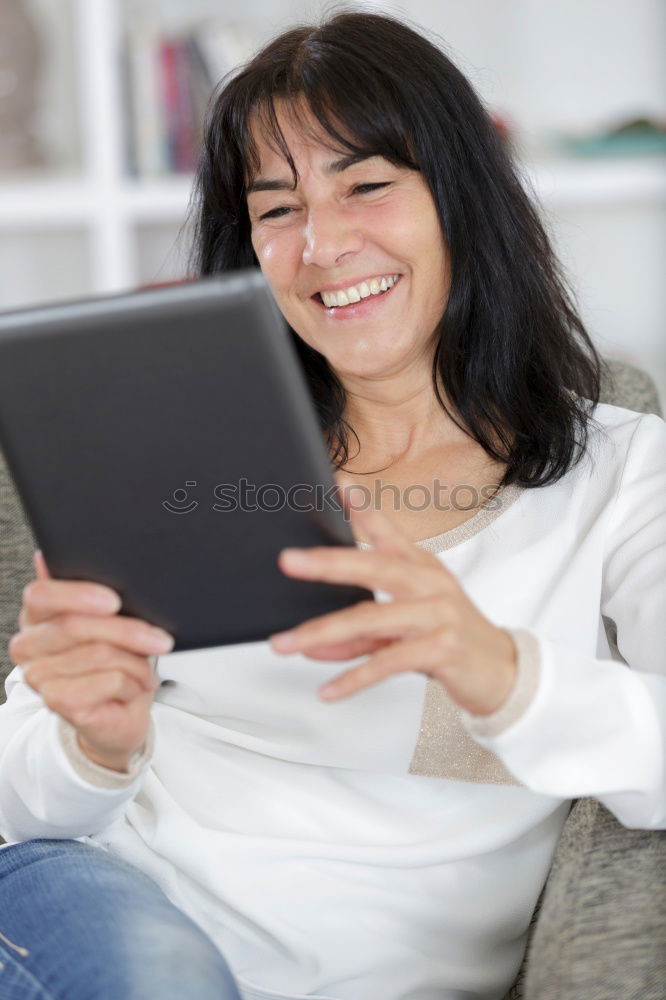 Similar – Image, Stock Photo Smiling African woman using digital tablet outdoors.