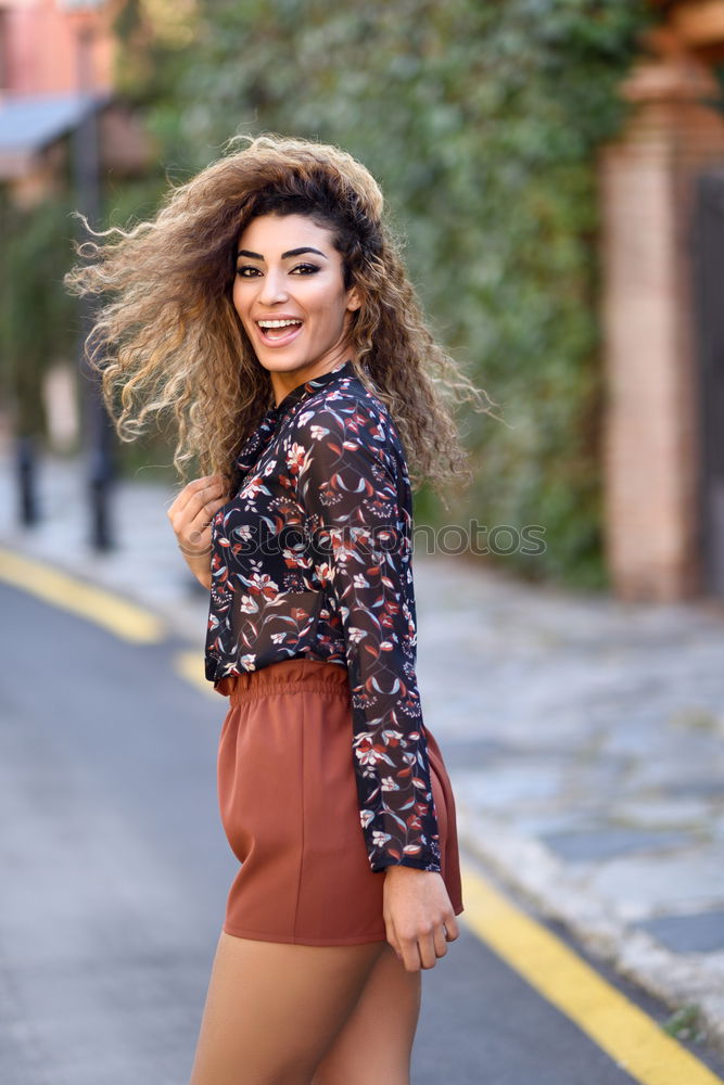 Similar – Smiling young Arab woman with black curly hairstyle