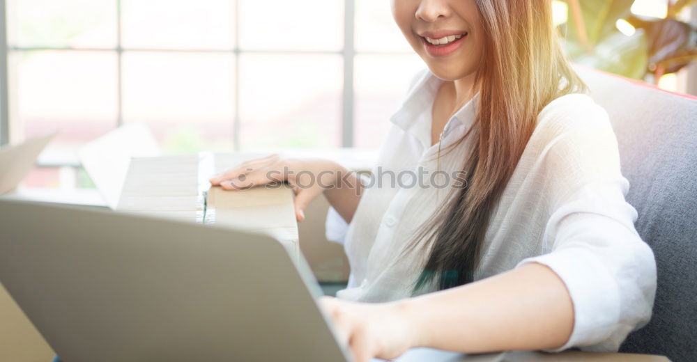 Similar – Young asian woman smiling and using tablet