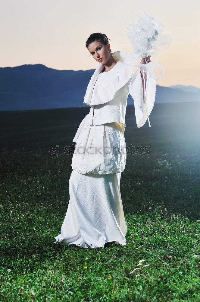 Image, Stock Photo Blonde woman and bearded man posing with plant branches in the hand at sunset, and blue sky in the background.