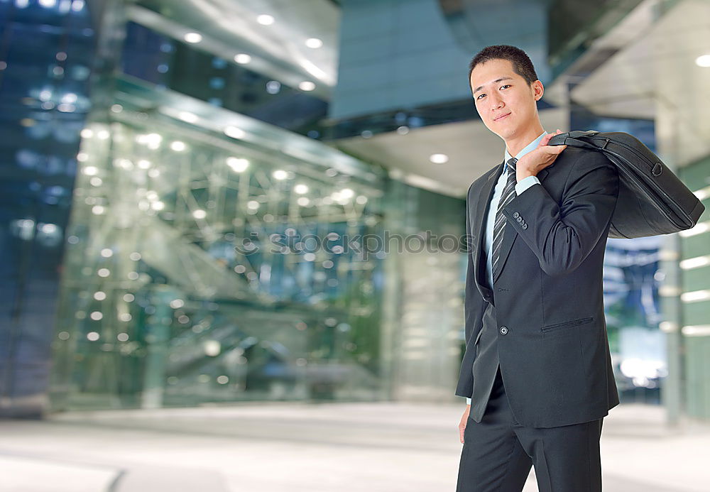 Similar – young businessman walking at the airport using his mobile phone