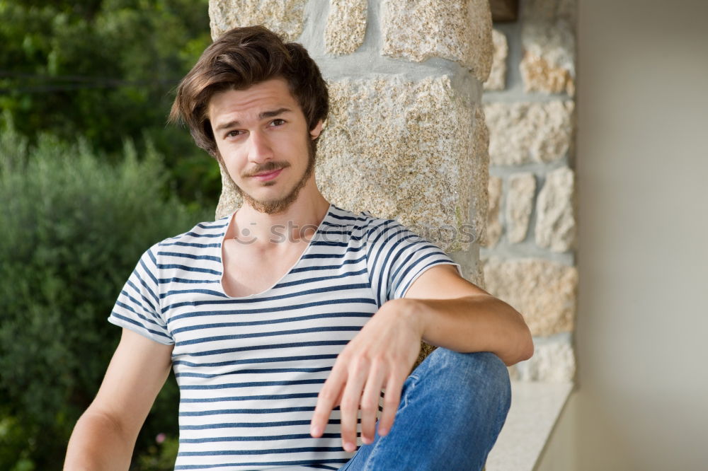 Similar – Young man sitting on the floor in urban background