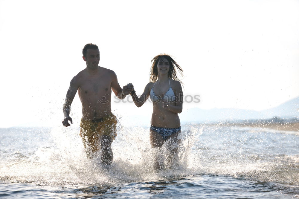 Similar – Image, Stock Photo Crop couple in swimsuit holding hands