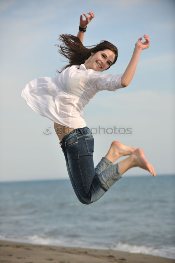 Similar – Girl with sunglasses, short jeans and long legs, jumps happily in summer, happily up on the trampoline, with blue sky in the background.