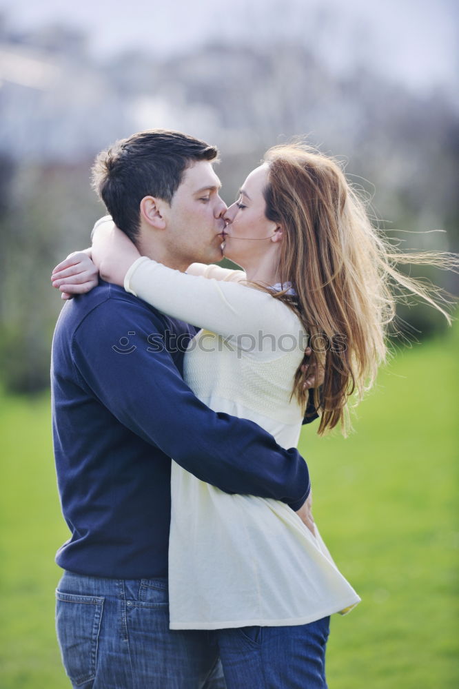 Similar – Image, Stock Photo Young loving couple kissing in the street.